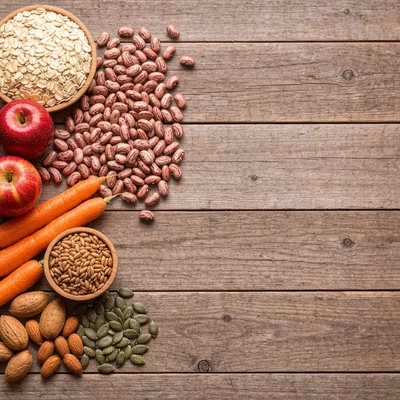 Assortment of fiber-rich foods like oats, beans, apples, and whole grains